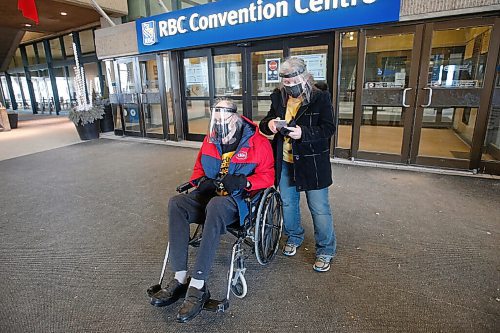 JOHN WOODS / WINNIPEG FREE PRESS
Kathy and George Freeman, 79, wait for their ride after getting a vaccination shot at the  Convention Centre. George Freeman and other members of the general public over 95, and 75 for indigenous, were allowed to get their COVID-19 vaccinations today at the Convention Centre in Winnipeg Sunday, March 1, 2021. 

Reporter: DaSilva
