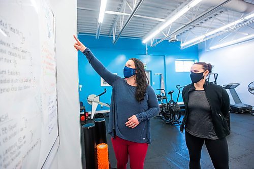 MIKAELA MACKENZIE / WINNIPEG FREE PRESS

Co-owners Chelsea White (left) and Lindsay Jurkowski point out pandemic jokes on the whiteboard at Advantage Conditioning in Winnipeg on Tuesday, March 2, 2021. They're happy with the extension, but are struggling with the restrictions. For Temur story.

Winnipeg Free Press 2021