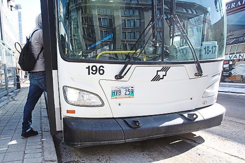 MIKE DEAL / WINNIPEG FREE PRESS
People get on a transit bus at the Graham and Vaughan bus stop in downtown Winnipeg Wednesday morning. 
210303 - Wednesday, March 3, 2021.