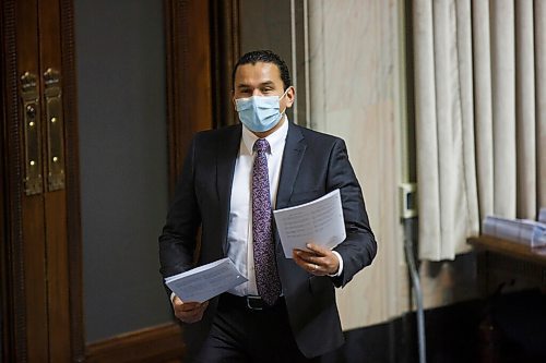 MIKE DEAL / WINNIPEG FREE PRESS
NDP's Wab Kinew, Leader of the Opposition picks up two of the bills that were released at the beginning of the third session of the 42nd legislature at the Manitoba Legislative building Wednesday. 
210303 - Wednesday, March 03, 2021.