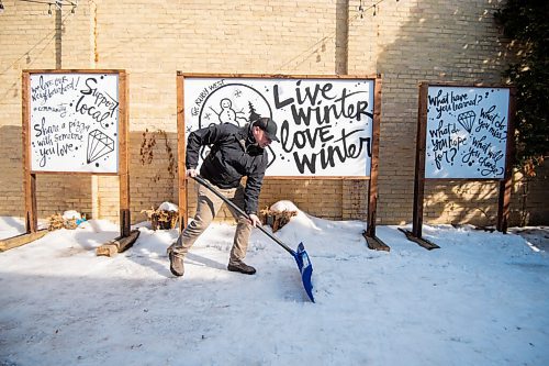 MIKE SUDOMA / WINNIPEG FREE PRESS 
Jamie Hilland an owner of the Ruby West coffee shop on Westminster, cleans snow off of the spot where the cafés temporary patio had sat last year.
March 5, 2021