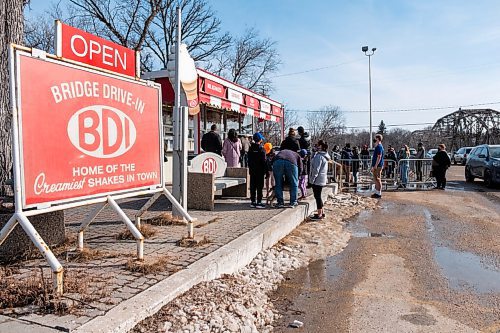 Daniel Crump / Winnipeg Free Press. Dozens of people lined up before 2pm on Saturday waiting for the Bridge Drive-In, better known just as BDI, to open for the season. The line continued to grow as the ice cream began to flow. March 6, 2021.