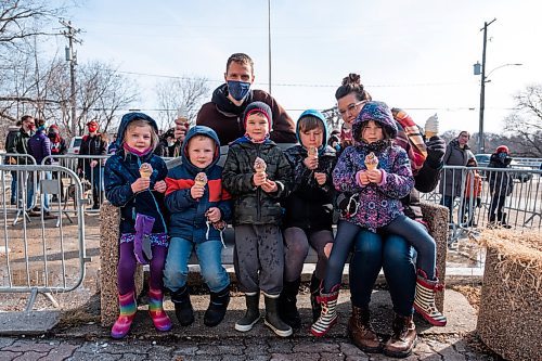 Daniel Crump / Winnipeg Free Press. Andrew and Jolene Hedlin with their kids, nieces and nephews enjoy chocolate sprinkle ice cream cones at the Bridge Drive-In on Saturday afternoon. March 6, 2021.