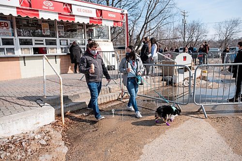 Daniel Crump / Winnipeg Free Press. Travis Dekezel and Monica Mai go off to eat the ice cream they just purchased at the Bridge Drive-In. The couple was first in line as the famed ice cream spot opened up for the season Saturday afternoon. March 6, 2021.