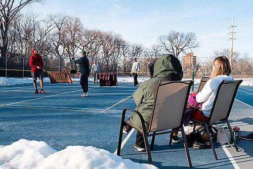 Daniel Crump / Winnipeg Free Press. Marilyn Peters Kliewer and Brittany Swail watch as three generations of the Kliewer family enjoy the warm spring weather while playing pickle ball on a tennis court that has been cleared of snow. March 6, 2021.