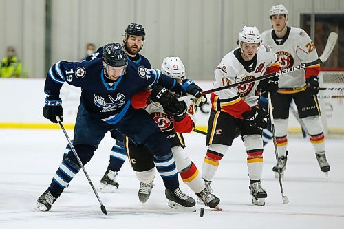 JOHN WOODS / WINNIPEG FREE PRESS
Manitoba Moose David Gustafsson (19) and Stockton Heats Connor Zary (47) chase the puck during first period AHL action in Winnipeg on Monday, March 8, 2021.

Reporter: Allen