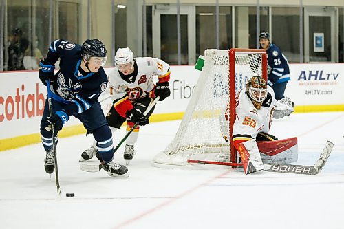 JOHN WOODS / WINNIPEG FREE PRESS
Manitoba Moose Cole Perfetti (17) makes his way around the as Stockton Heats goaltender Artyom Zagidulin (50) watches during first period AHL action in Winnipeg on Monday, March 8, 2021.

Reporter: Allen