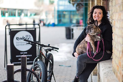 MIKAELA MACKENZIE / WINNIPEG FREE PRESS

Lana Bakun, owner of Kendrick's Outdoor Adventures, and her dog, Kendrick, pose for a photo in front of the outdoor equipment rental company at The Forks in Winnipeg on Wednesday, March 10, 2021. For Sabrina story.

Winnipeg Free Press 2021