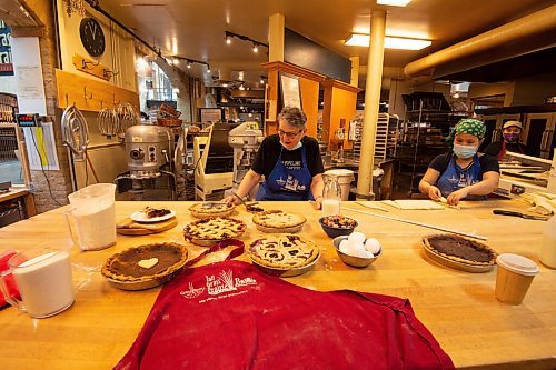 MIKE SUDOMA / WINNIPEG FREE PRESS
Tabitha Langel (left) and Muhku Klee (right) finish up with a few different types of pies at Tall Grass Prairie inside the Forks Market Wednesday
March 10, 2021