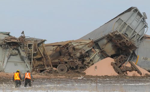 Brandon Sun CN Rail workers assess the scene of a train derailment at the intersection of Hwy. 354 and the CN Rail line near Norman, Man., in the RM of Daly on Thursday afternoon. No one was injured in the accident. (Bruce Bumstead/Brandon Sun)