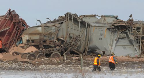 Brandon Sun CN Rail workers assess the scene of a train derailment at the intersection of Hwy. 354 and the CN Rail line near Norman, Man., in the RM of Daly on Thursday afternoon. No one was injured in the accident. (Bruce Bumstead/Brandon Sun)