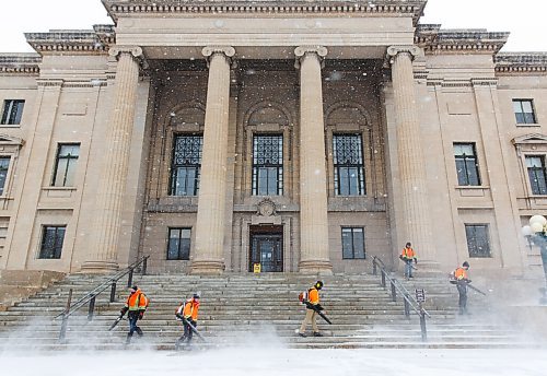 MIKE DEAL / WINNIPEG FREE PRESS
A crew armed with leaf blowers deals with the layer of snow that accumulated on the stairs of the Manitoba Legislative building Thursday morning. 
210311 - Thursday, March 11, 2021.