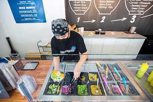 MIKAELA MACKENZIE / WINNIPEG FREE PRESS

Zhehong Wen, owner of Poke Mono, puts together a poke bowl order at his restaurant (which opened on the eve of the pandemic shutdown) in Winnipeg on Thursday, March 11, 2021. For Ben Waldman story.

Winnipeg Free Press 2021