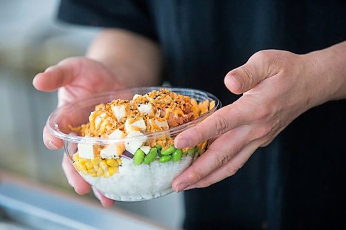 MIKAELA MACKENZIE / WINNIPEG FREE PRESS

Zhehong Wen, owner of Poke Mono, puts together a poke bowl order at his restaurant (which opened on the eve of the pandemic shutdown) in Winnipeg on Thursday, March 11, 2021. For Ben Waldman story.

Winnipeg Free Press 2021