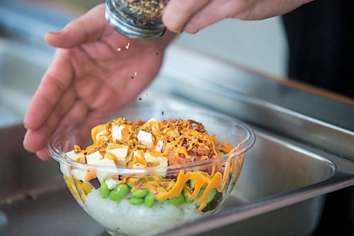 MIKAELA MACKENZIE / WINNIPEG FREE PRESS

Zhehong Wen, owner of Poke Mono, puts together a poke bowl order at his restaurant (which opened on the eve of the pandemic shutdown) in Winnipeg on Thursday, March 11, 2021. For Ben Waldman story.

Winnipeg Free Press 2021