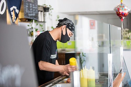 MIKAELA MACKENZIE / WINNIPEG FREE PRESS

Zhehong Wen, owner of Poke Mono, puts together a poke bowl order at his restaurant (which opened on the eve of the pandemic shutdown) in Winnipeg on Thursday, March 11, 2021. For Ben Waldman story.

Winnipeg Free Press 2021