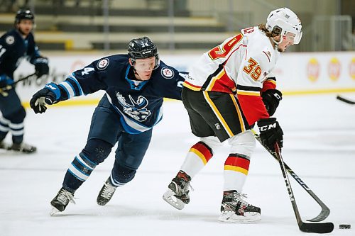 JOHN WOODS / WINNIPEG FREE PRESS
Manitoba Moose Nicholas Jones (24) tries to stop Stockton Heats Luke Philp (39) during first period AHL action in Winnipeg on Thursday, March 11, 2021.

Reporter: Allen