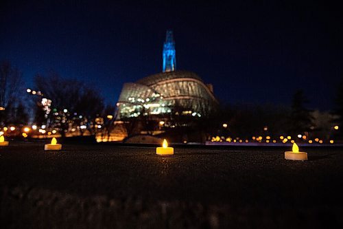 MIKE SUDOMA / WINNIPEG FREE PRESS
Tea light candles line the edge of the bowl at the Plaza at the Forks as the Canadian Museum for Human Rights looms in the background. Hundreds of the candles can be found around the Winnipeg sign beside Scotia Bank Stage to commemorate the lives lost during the first year of the Covid 19 pandemic. The top of the Canada Museum for Human Rights tower will be lit up blue in tribute to the health care workers who have been on the frontlines of the pandemic. The memorial will be on display form March 11-14.
March 10, 2021