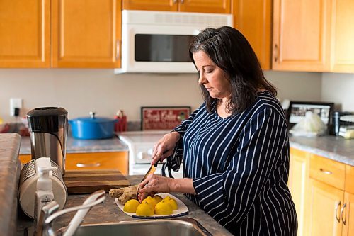 MIKAELA MACKENZIE / WINNIPEG FREE PRESS

Michelle Bailey, who is 51 and getting a covid vaccine next week as she is eligible due to underlying conditions, cuts up lemons (for immune-boosting lemon-ginger shots) in her home in Winnipeg on Friday, March 12, 2021. For Kevin Rollason story.

Winnipeg Free Press 2021