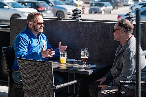 Daniel Crump / Winnipeg Free Press. Trevor Finch (left) had a drink with his neighbour Paul Thomas on the patio at Fionns on Grant Avenue Saturday afternoon. March 13, 2021.