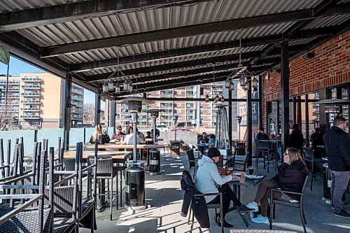 Daniel Crump / Winnipeg Free Press. The patio at Fionns on Grant Avenue is busy with customers out enjoying food and drink with their friends and family Saturday afternoon as new restrictions regarding gatherings with non household members are eased. March 13, 2021.