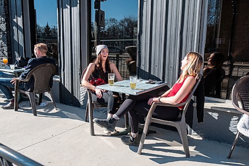 Daniel Crump / Winnipeg Free Press. Meagan Shepherd (left) and Rheann Brownstone enjoy some drinks on the patio at Bar Italia Saturday afternoon. March 13, 2021.