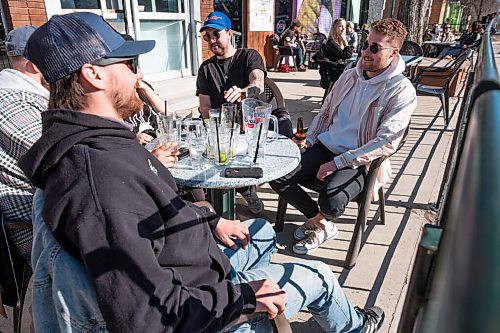 Daniel Crump / Winnipeg Free Press. (L to R) Jack Mackenzie Jackson and Matt ONeill have some drinks with friends as they get together on the patio at Bar Italia on Saturday afternoon. March 13, 2021.