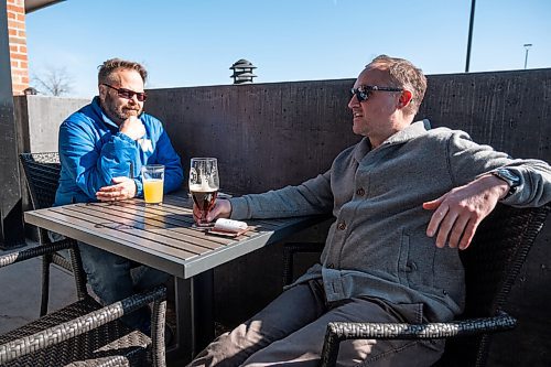 Daniel Crump / Winnipeg Free Press. Trevor Finch (left) had a drink with his neighbour Paul Thomas on the patio at Fionns on Grant Avenue Saturday afternoon. March 13, 2021.