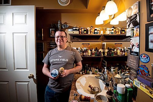 MIKE SUDOMA / WINNIPEG FREE PRESS
Stone Field Shaving Co owner, Jonathan Steinfeld, shows off a couple of products he sells as he stands amongst the collection of shaving memorabilia inside his self proclaimed man cave of shaving Friday morning
March 12, 2021