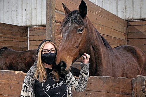 Canstar Community News Kristy McFee stands with therapy horse Sue at West Wind Stables on March 9. (GABRIELLE PICHÉ/CANSTAR COMMUNITY NEWS/HEADLINER)