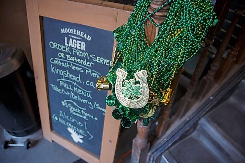 MIKE DEAL / WINNIPEG FREE PRESS
Green beaded necklaces great customers to the King's Head Pub (120 King Street) Wednesday morning to celebrate St. Patrick's Day. 
210317 - Wednesday, March 17, 2021.