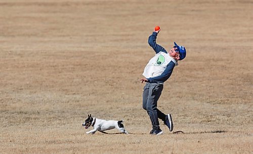 MIKE DEAL / WINNIPEG FREE PRESS
Davis Moore plays with dog Rosie at La Barriere park Friday afternoon.
210319 - Friday, March 19, 2021.