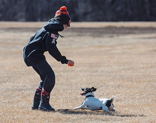 MIKE DEAL / WINNIPEG FREE PRESS
Cole Moore plays with dog Rosie at La Barriere park Friday afternoon.
210319 - Friday, March 19, 2021.