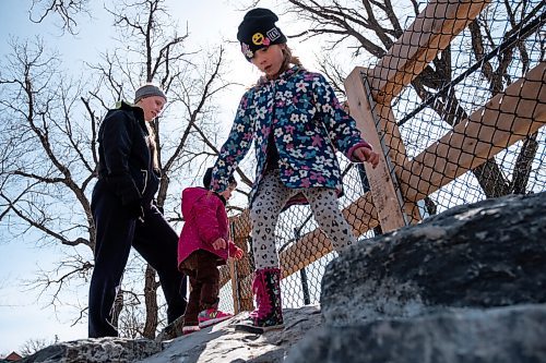 Daniel Crump / Winnipeg Free Press. Teagan Sleeva plays with her kids Deslyn (6) and Rhettley (1) on some rocks at a playground at the Assiniboine Park Zoo. March 20, 2021.