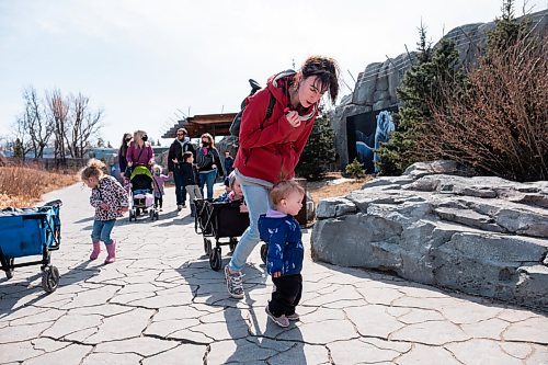Daniel Crump / Winnipeg Free Press. Sarah English walks with her kids Rose (front) and Rori (in the wagon) at the Assiniboine Park Zoo. Many people were out enjoying the record breaking spring weather. March 20, 2021.