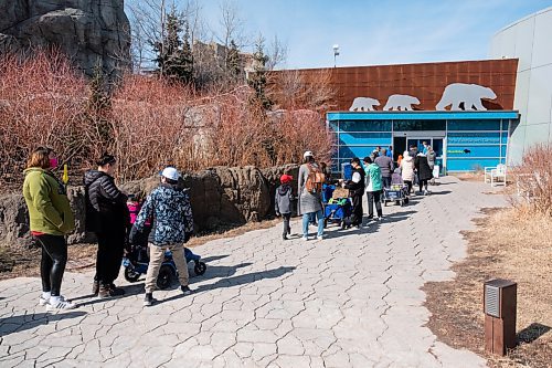 Daniel Crump / Winnipeg Free Press. People lineup at the Journey to Churchill exhibit at the Assiniboine Park Zoo. Record breaking high temperatures in Manitoba brought many people outside Saturday afternoon. March 20, 2021.