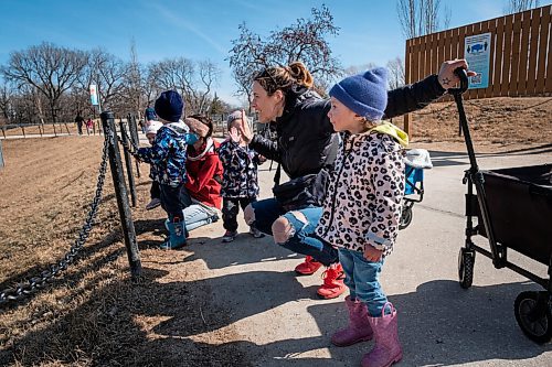 Daniel Crump / Winnipeg Free Press. Sarah Kristy (middle right)) high-fives her friends daughter, Rose English. The two families, from Shiloh, Manitoba, decided to spend the day together at the Assiniboine Park Zoo in Winnipeg. March 20, 2021.