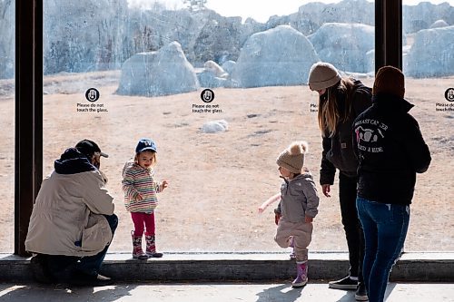 Daniel Crump / Winnipeg Free Press. Alice Edinger (left) and Isla Waldner (right) share a socially distanced glance  with each other at the polar bear exhibit. The two kids, who havent met before, are both at the zoo enjoying the warm spring weather. March 20, 2021.