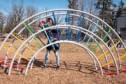 Daniel Crump / Winnipeg Free Press. Cassidy Hebert watches her son, Brandon, as they play together on a climbing structure at a playground at the Assiniboine Park Zoo. March 20, 2021.
