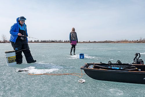Daniel Crump / Winnipeg Free Press. Roselle Turenne (left) and Lori Slobodian (right) chat as they fish on a lake at Fort Whyte Alive. Today is the warmest March 20 on record in Winnipeg. March 20, 2021.
