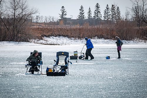 Daniel Crump / Winnipeg Free Press. People icefish on lake at Fort Whyte Centre on a record setting first day of spring in Winnipeg. March 20, 2021.