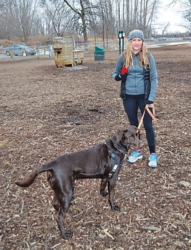Canstar Community News Tanya Kapusta and her dog, Blue, show off the phone that a Good Samaritan found and returned to her after her car was broken into at Maple Grove dog park.