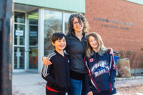 MIKAELA MACKENZIE / WINNIPEG FREE PRESS

Sara Robert and her kids, Elodie (nine) and Drew (seven), pose for a portrait at the closed River Heights Library in Winnipeg on Monday, March 22, 2021. For Jen Zoratti story.

Winnipeg Free Press 2021