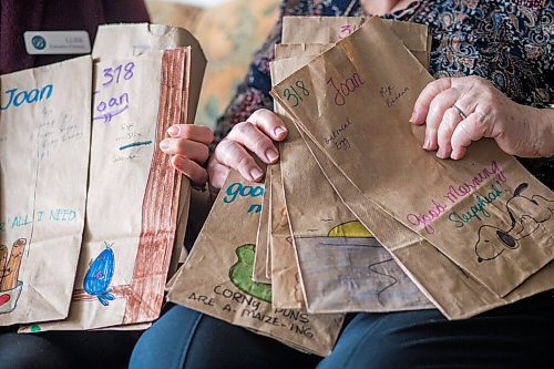 MIKAELA MACKENZIE / WINNIPEG FREE PRESS

Executive director Luise Sawatzky (left) and resident Joan Grenon pose for a photo with the decorated bags at Boulton River Heights Retirement Community complex in Winnipeg on Wednesday, March 24, 2021. Every day servers at the complex are transforming about 100 plain brown paper bags into works of art as residents take their meals in their suites during lockdown. For Doug story.

Winnipeg Free Press 2021