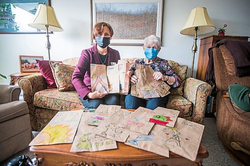 MIKAELA MACKENZIE / WINNIPEG FREE PRESS

Executive director Luise Sawatzky (left) and resident Joan Grenon pose for a photo with the decorated bags at Boulton River Heights Retirement Community complex in Winnipeg on Wednesday, March 24, 2021. Every day servers at the complex are transforming about 100 plain brown paper bags into works of art as residents take their meals in their suites during lockdown. For Doug story.

Winnipeg Free Press 2021