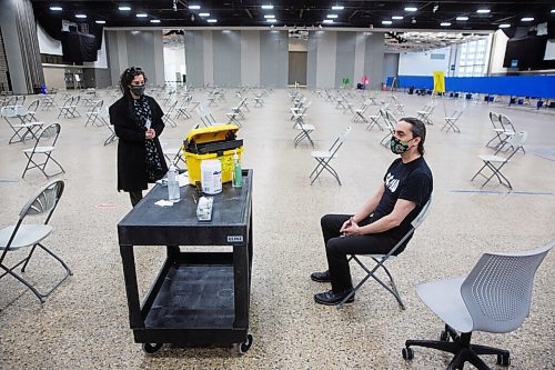 MIKE DEAL / WINNIPEG FREE PRESS
Grand Chief Arlen Dumas waits to receive his COVID-19 immunization from Dr. Marcia Anderson, public health lead, First Nation Pandemic Response Coordination Team at the Vaccination Supercentre in the RBC Convention Centre Thursday morning.
210325 - Thursday, March 25, 2021.