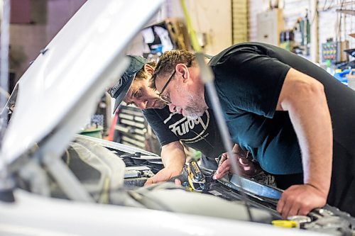 MIKAELA MACKENZIE / WINNIPEG FREE PRESS

Mechanic Ted Paszko (left) and Mike Timlick, owner of the Auto Centre, work on a car at the garage in Winnipeg on Thursday, March 25, 2021.  For Ben Waldman story.

Winnipeg Free Press 2021