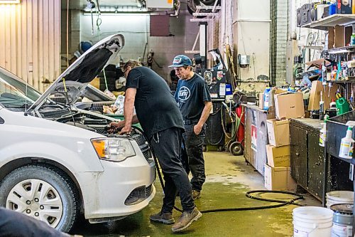 MIKAELA MACKENZIE / WINNIPEG FREE PRESS

Mike Timlick, owner of the Auto Centre (left), and mechanic Ted Paszko work on a car at the garage in Winnipeg on Thursday, March 25, 2021.  For Ben Waldman story.

Winnipeg Free Press 2021