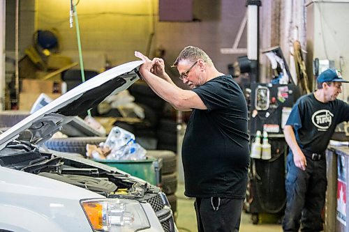 MIKAELA MACKENZIE / WINNIPEG FREE PRESS

Mike Timlick, owner of the Auto Centre (left), and mechanic Ted Paszko work on a car at the garage in Winnipeg on Thursday, March 25, 2021.  For Ben Waldman story.

Winnipeg Free Press 2021