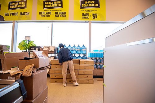 MIKE SUDOMA / WINNIPEG FREE PRESS 
Clerk, Goghi Castello, stocks a shelf in the aisle of the brand new Freshco store located on Sargeant and Sherbrooke. The store is open for business Friday morning
March 21, 2021